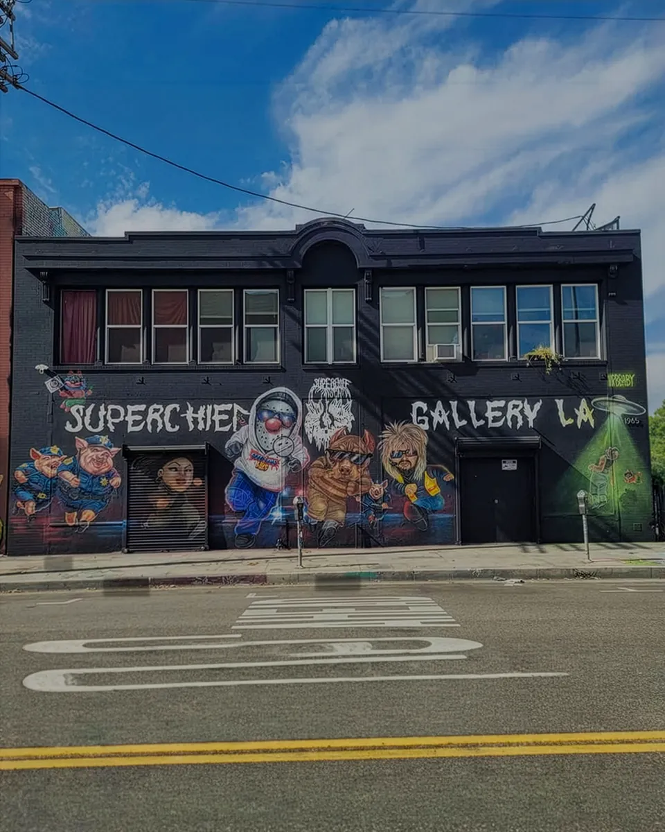 The painted facade of Super Chief Gallery LA under a blue sky.