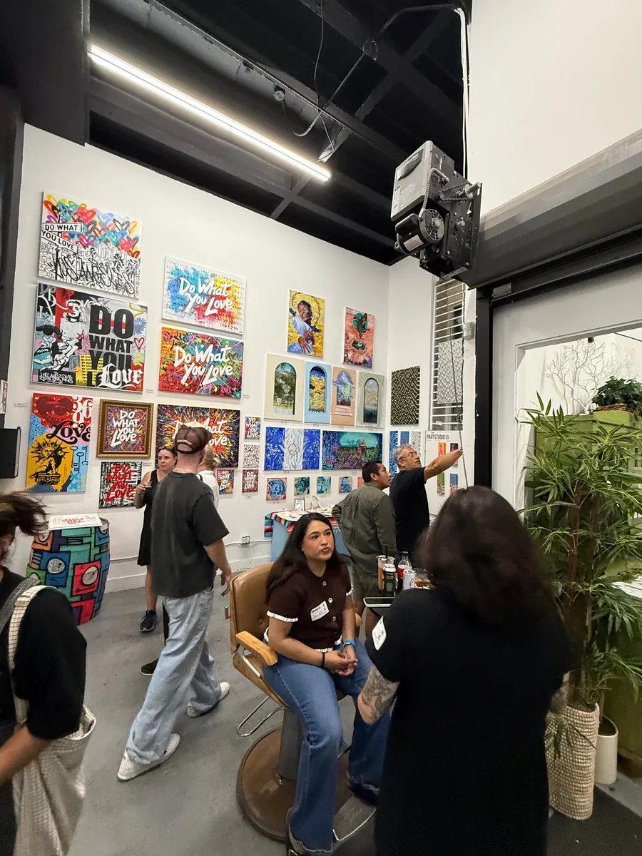 A busy gallery on Gallery Row, its walls hung edge to edge with prints.